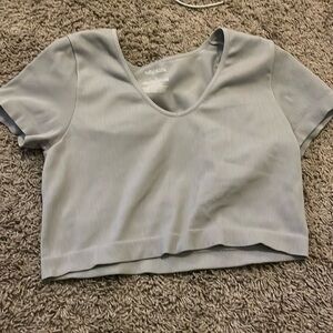It’s a grey cropped ribbed shirt